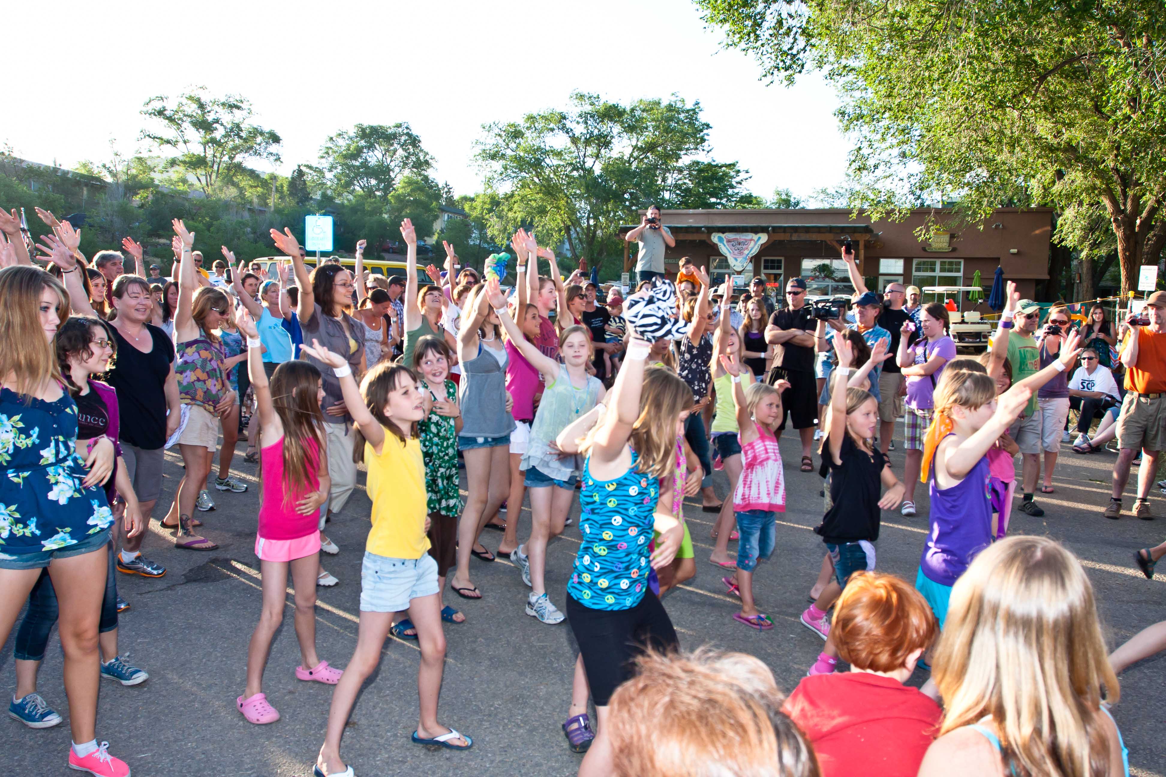 Group of People Dancing in the Parking Lot